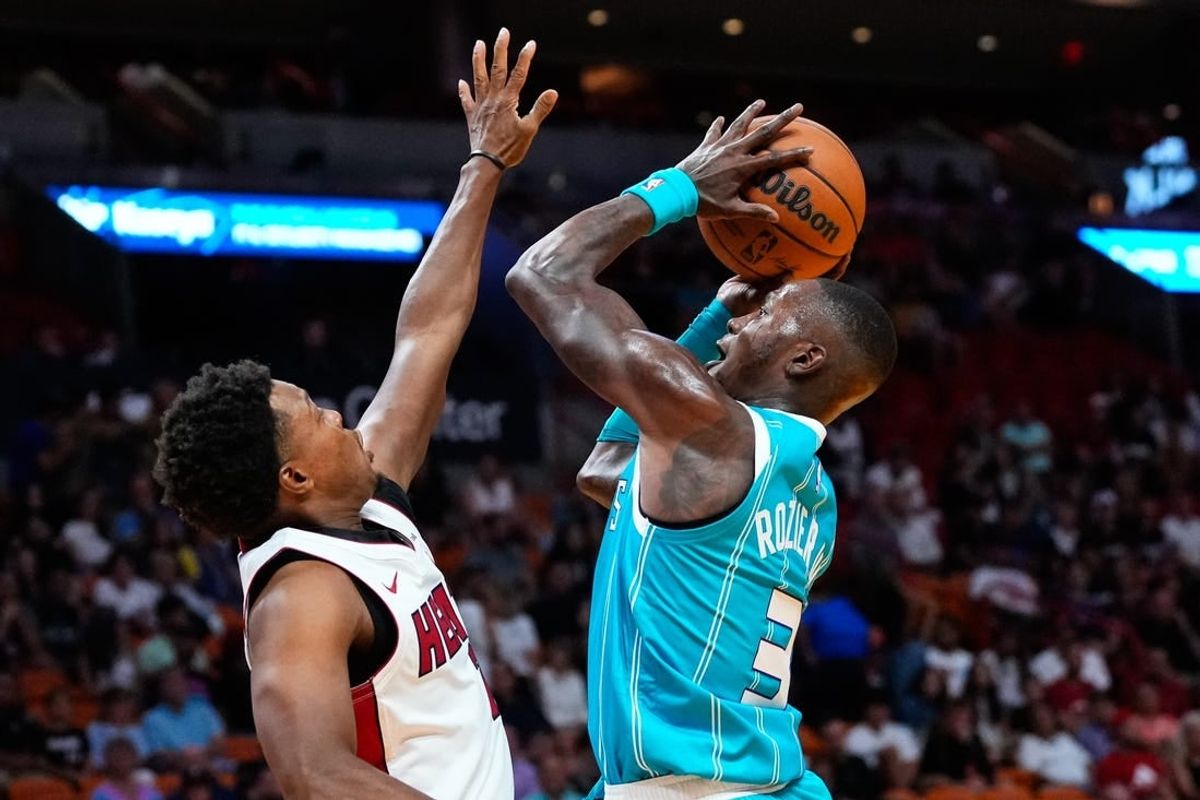 Oct 10, 2023; Miami, Florida, USA; Charlotte Hornets guard Terry Rozier (3) shoots over Miami Heat guard Kyle Lowry (7) during the first quarter at Kaseya Center.