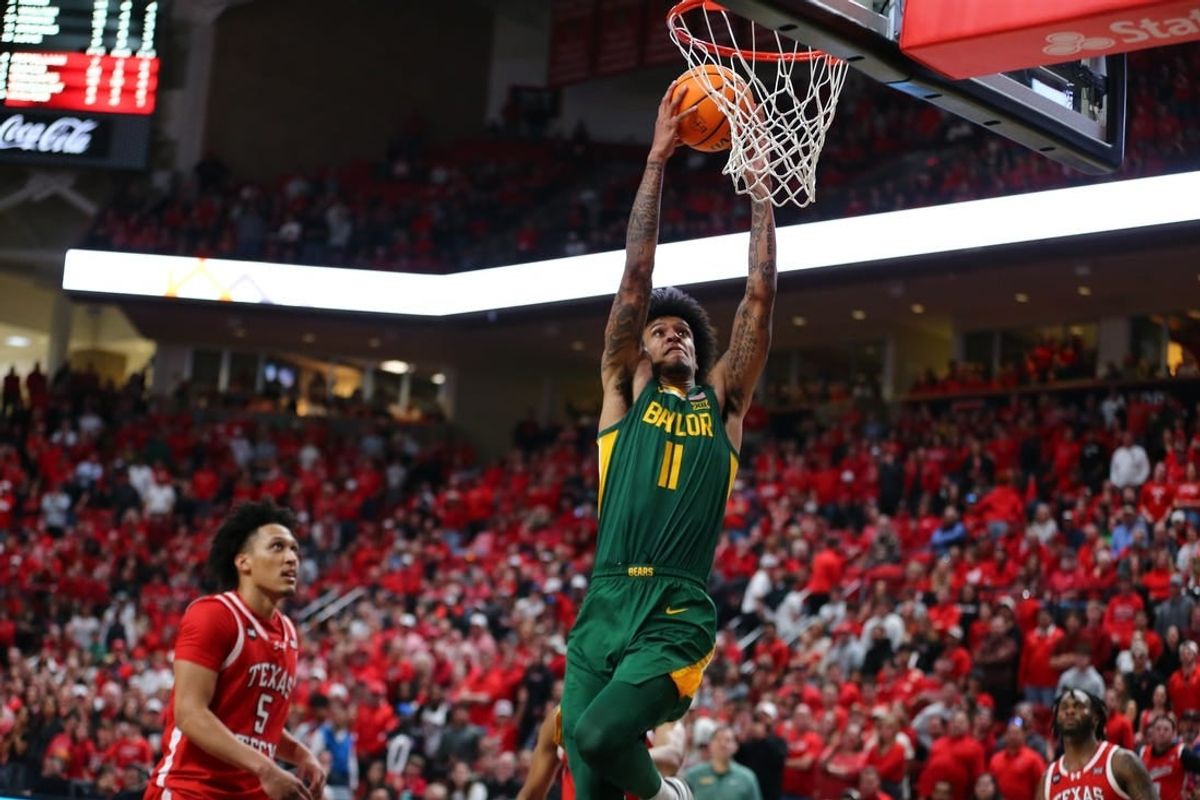 Mar 9, 2024; Lubbock, Texas, USA;  Baylor Bears forward Jalen Bridges (11) dunks the ball against Texas Tech Red Raiders guard Darrion Williams (5) in the second half at United Supermarkets Arena.