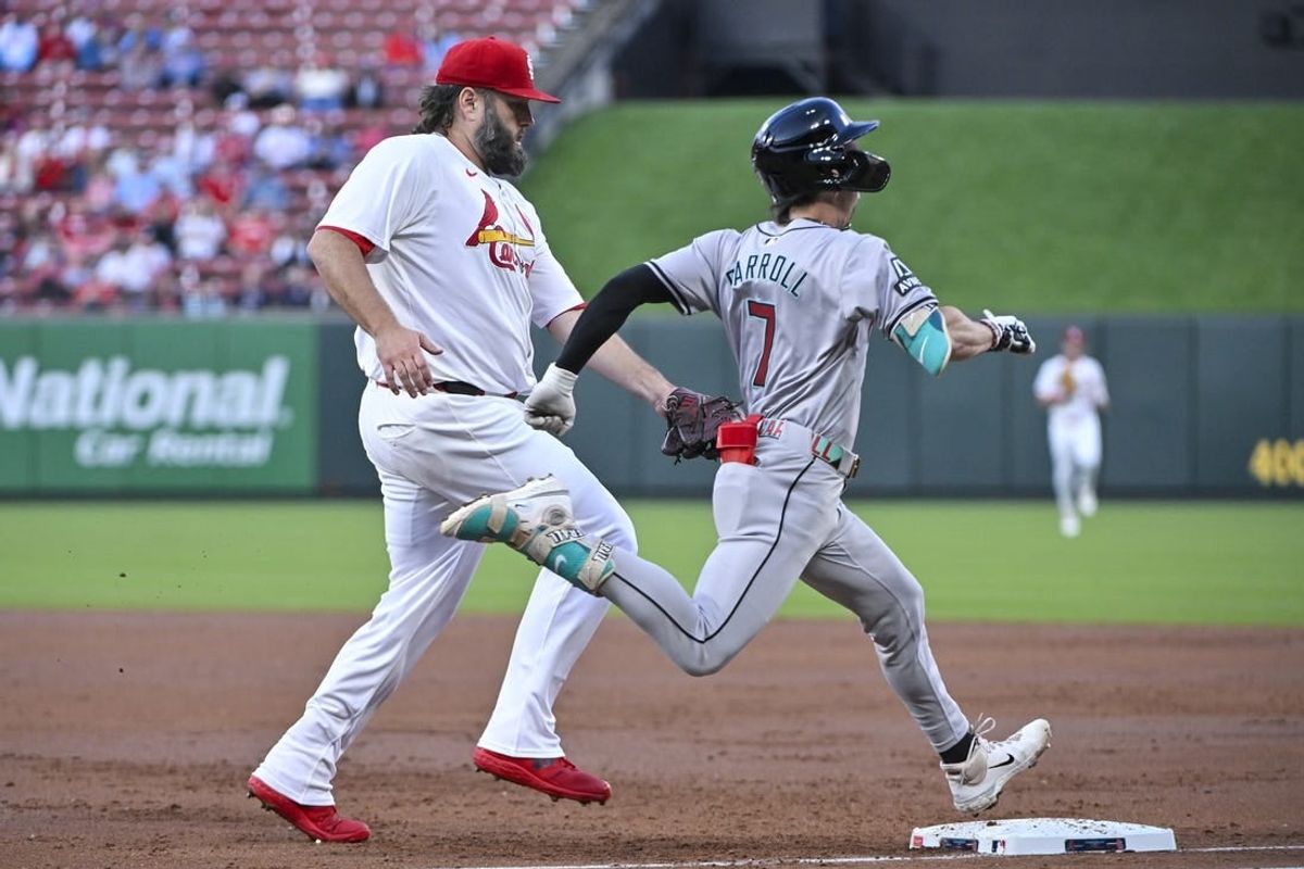 Apr 22, 2024; St. Louis, Missouri, USA;  Arizona Diamondbacks center fielder Corbin Carroll (7) beats St. Louis Cardinals starting pitcher Lance Lynn (31) to first base for a single during the second inning at Busch Stadium.