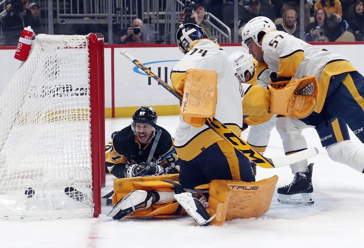 Apr 15, 2024; Pittsburgh, Pennsylvania, USA;  Pittsburgh Penguins center Sidney Crosby (87) scores a goal against Nashville Predators goaltender Juuse Saros (74) during the first period at PPG Paints Arena.
