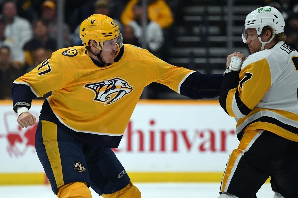 Nov 28, 2023; Nashville, Tennessee, USA; Nashville Predators right wing Michael McCarron (47) and Pittsburgh Penguins defense John Ludvig (7) exchange hits in a fight during the second period at Bridgestone Arena.