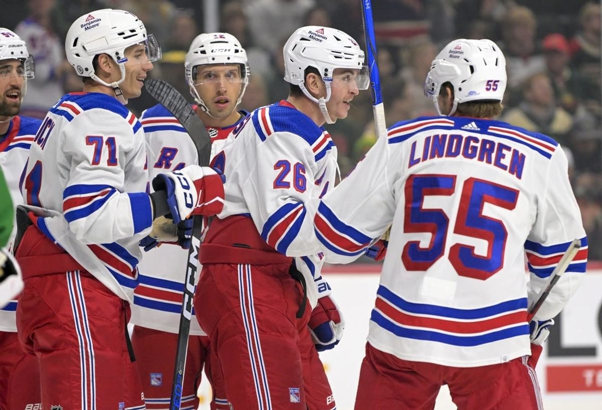 Nov 4, 2023; Saint Paul, Minnesota, USA; New York Rangers forward Jimmy Vesey (26) celebrates his goal against the Minnesota Wild with forward Tyler Pitlick (71) and defenseman Ryan Lindgren (55) during the first period at Xcel Energy Center.