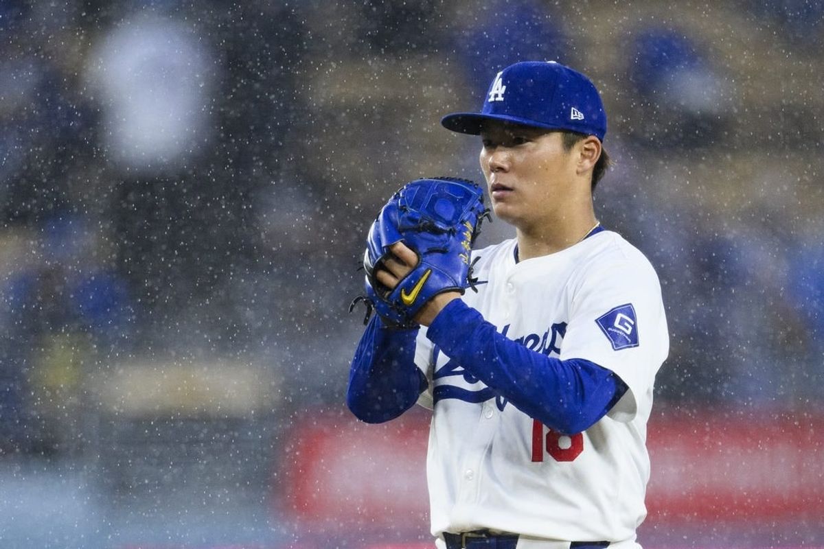 Mar 30, 2024; Los Angeles, California, USA;  Los Angeles Dodgers starting pitcher Yoshinobu Yamamoto (18) prepares to pitch during the fourth inning against the St. Louis Cardinals at Dodger Stadium.