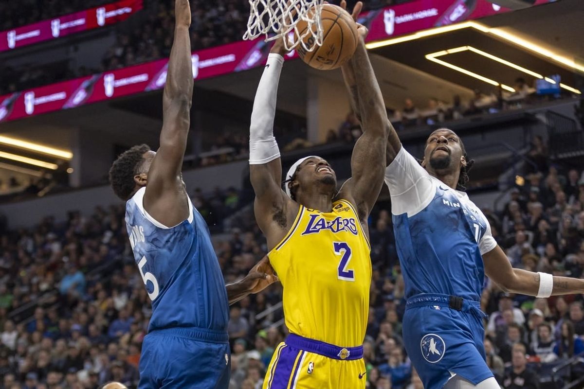Dec 21, 2023; Minneapolis, Minnesota, USA; Minnesota Timberwolves center Naz Reid (11) jumps up and blocks a shot from Los Angeles Lakers forward Jarred Vanderbilt (2) as Minnesota Timberwolves guard Anthony Edwards (5) plays defense in the first half at Target Center.