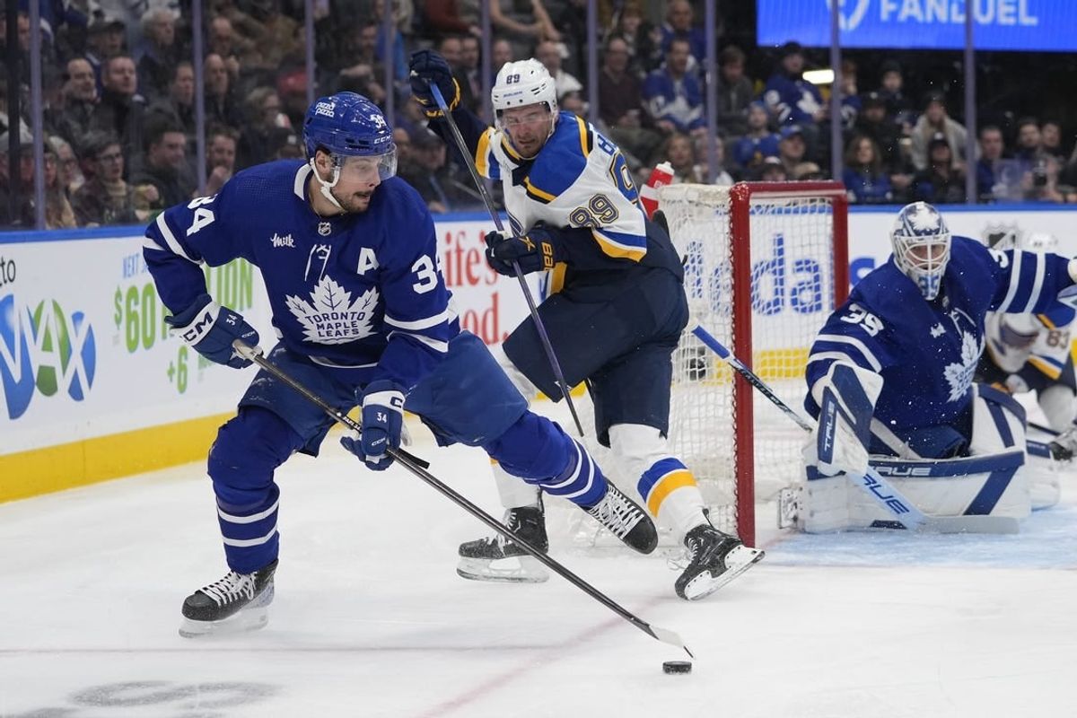 Feb 13, 2024; Toronto, Ontario, CAN; Toronto Maple Leafs forward Auston Matthews (34) goes to clear a rebound as St. Louis Blues forward Pavel Buchnevich (89) looks on during the second period Scotiabank Arena.