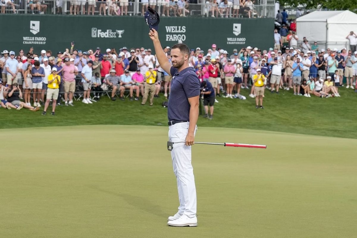 May 7, 2023; Charlotte, North Carolina, USA; Wyndham Clark celebrates to the gallery after his win during the final round of the Wells Fargo Championship golf tournament.
