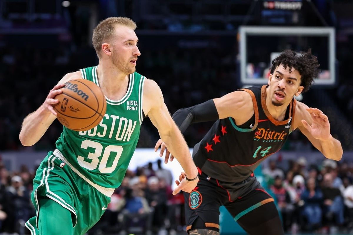 Mar 17, 2024; Washington, District of Columbia, USA; Boston Celtics forward Sam Hauser (30) drives to the basket against Washington Wizards guard Jules Bernard (14) during the first half of the game at Capital One Arena.
