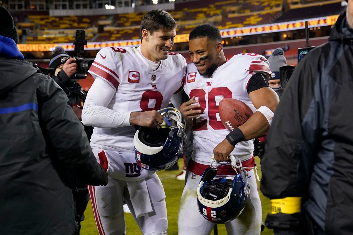The Giants re-signed Daniel Jones (l.) but franchise tagged Saquon Barkley