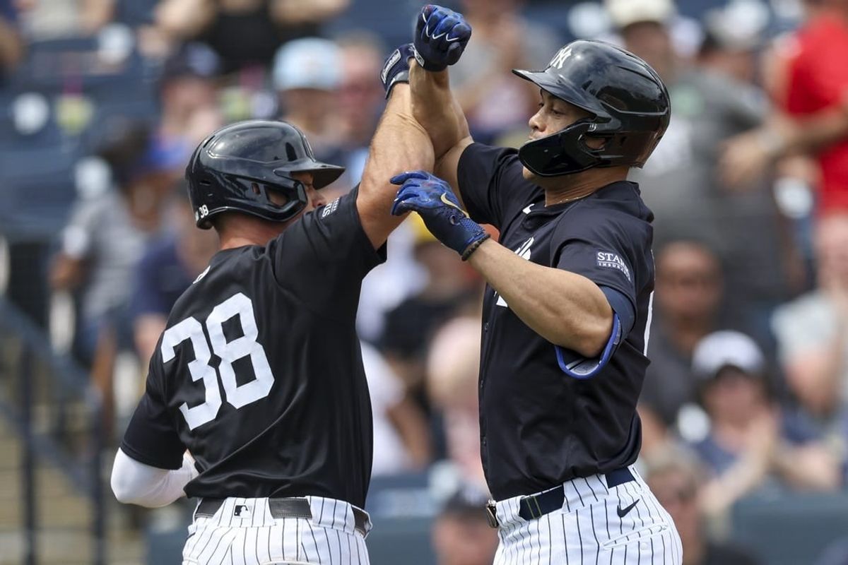 Mar 16, 2024; Tampa, Florida, USA;  New York Yankees right fielder Giancarlo Stanton (27) is congratulated by catcher Ben Rorvedt (38) after hitting a two run home run at George M. Steinbrenner Field.