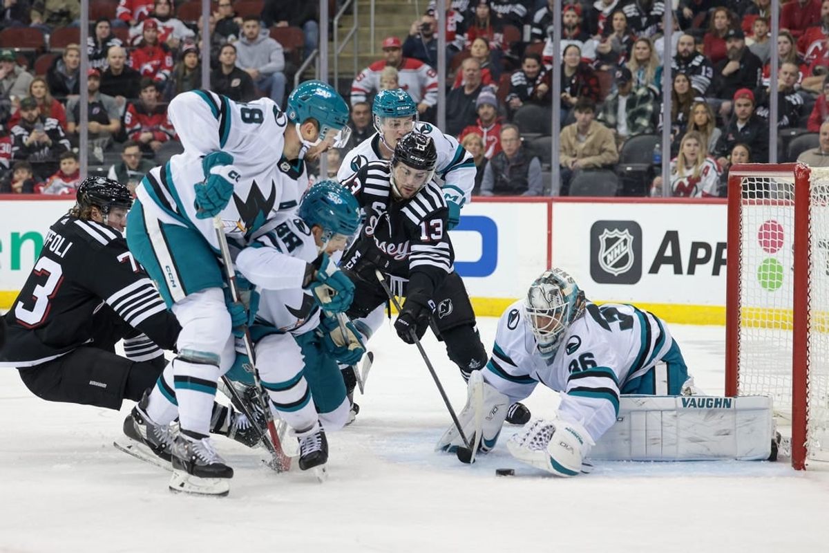 Dec 1, 2023; Newark, New Jersey, USA; San Jose Sharks goaltender Kaapo Kahkonen (36) covers the puck in front of New Jersey Devils center Nico Hischier (13) and right wing Tyler Toffoli (73) as center Tomas Hertl (48) and defenseman Mario Ferraro (38) defend during the first period at Prudential Center.