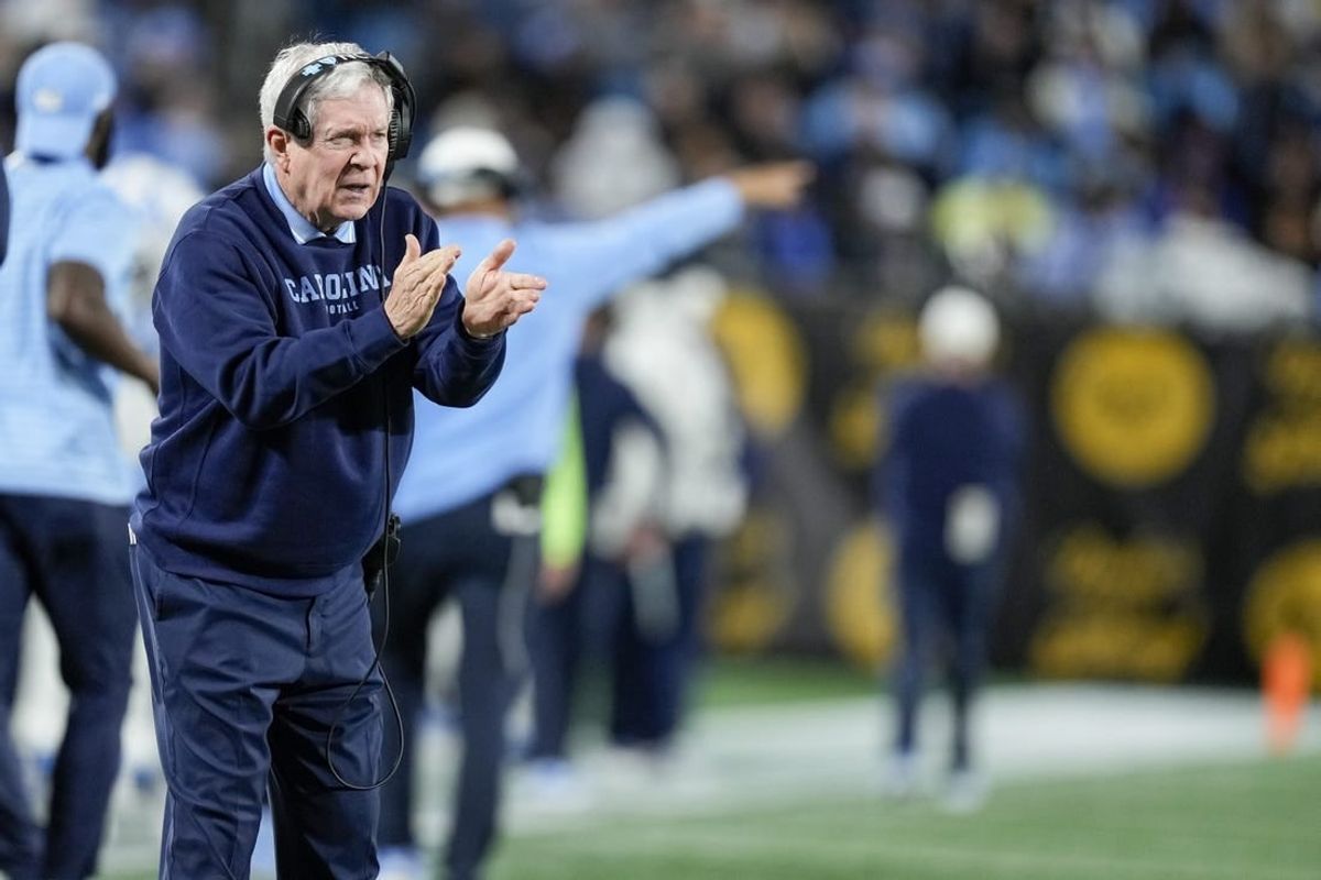 Dec 27, 2023; Charlotte, NC, USA; North Carolina Tar Heels head coach Mack Brown tries to cheer on his defense during the second half against the West Virginia Mountaineers at Bank of America Stadium.