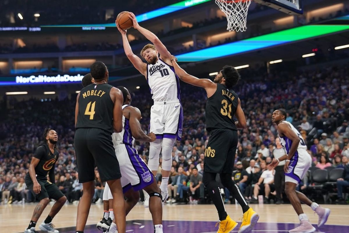 Nov 13, 2023; Sacramento, California, USA; Sacramento Kings forward Domantas Sabonis (10) grabs a rebound next to Cleveland Cavaliers center Jarrett Allen (31) in the first quarter at the Golden 1 Center.
