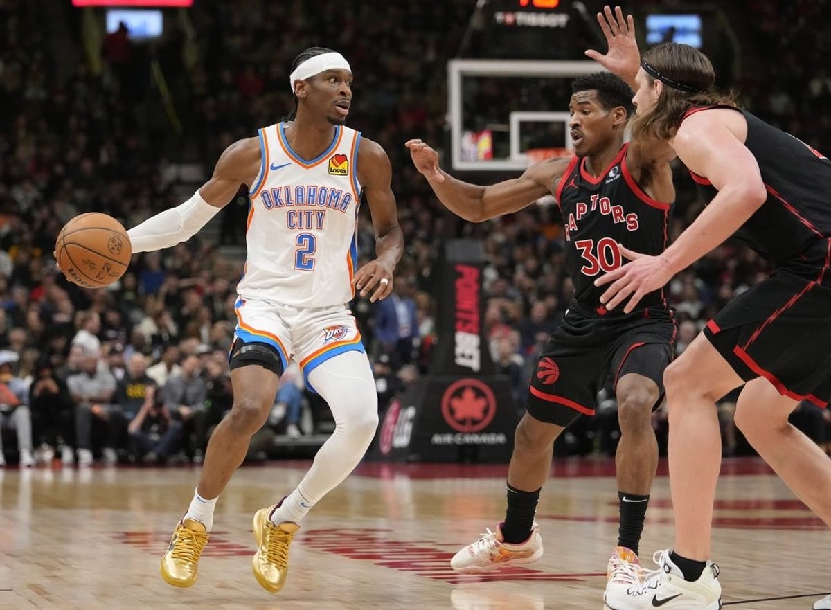 Mar 22, 2024; Toronto, Ontario, CAN; Oklahoma City Thunder guard Shai Gilgeous-Alexander (2) looks to make a play against Toronto Raptors guard Ochai Agbaji (30) and  forward Kelly Olynyk (41) during the first half at Scotiabank Arena.