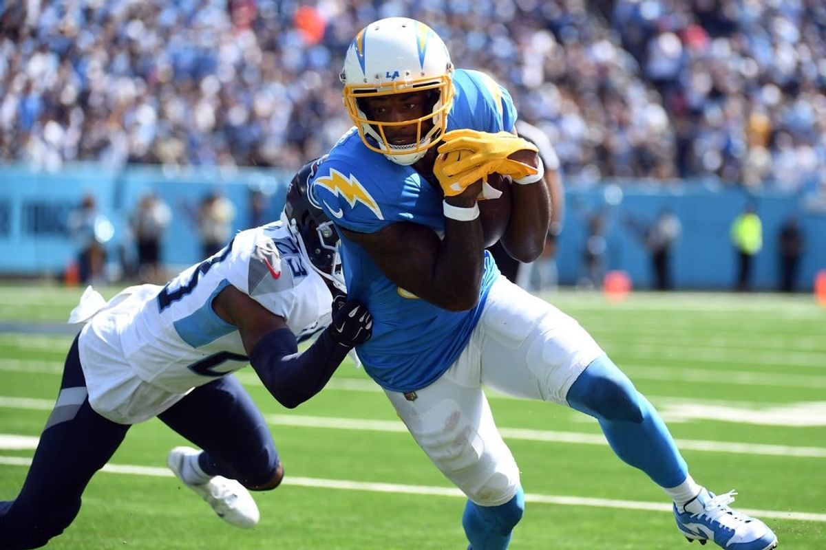 Sep 17, 2023; Nashville, Tennessee, USA; Los Angeles Chargers wide receiver Mike Williams (81) runs after a catch against Tennessee Titans cornerback Tre Avery (23) during the first half at Nissan Stadium.