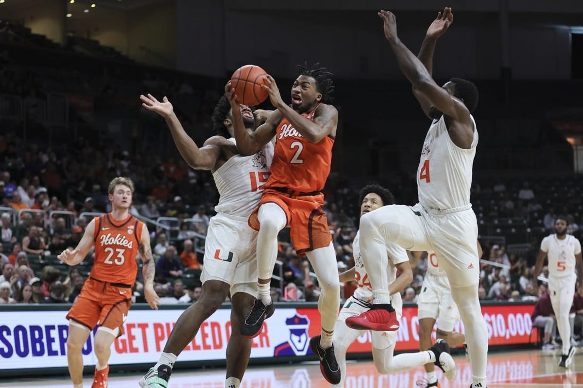 Feb 3, 2024; Coral Gables, Florida, USA; Virginia Tech Hokies guard MJ Collins (2) drives to the basket against Miami Hurricanes forward Norchad Omier (15) during the first half at Watsco Center.