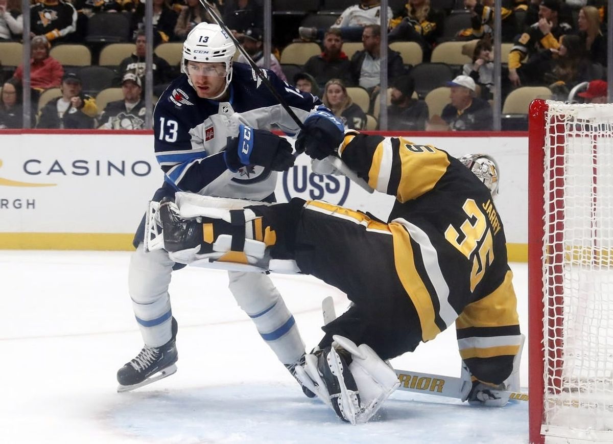 Feb 6, 2024; Pittsburgh, Pennsylvania, USA;  Winnipeg Jets center Gabriel Vilardi (13) breaks free after being held by Pittsburgh Penguins goaltender Tristan Jarry (35) during the second period at PPG Paints Arena.