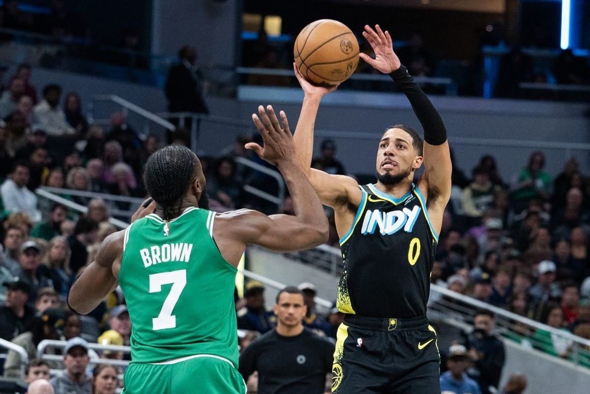 Jan 6, 2024; Indianapolis, Indiana, USA; Indiana Pacers guard Tyrese Haliburton (0) shoots the ball against Boston Celtics guard Jaylen Brown (7) in the second half at Gainbridge Fieldhouse.