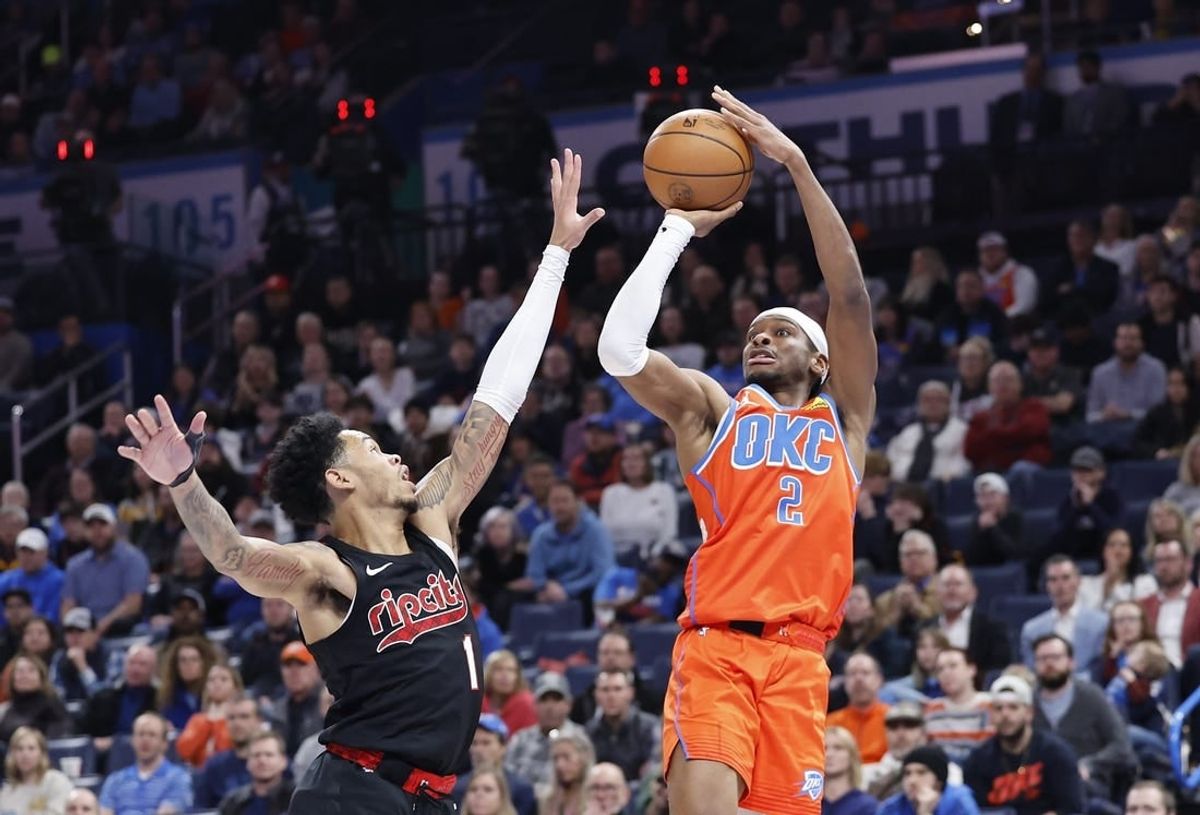 Jan 23, 2024; Oklahoma City, Oklahoma, USA; Oklahoma City Thunder guard Shai Gilgeous-Alexander (2) shoots as Portland Trail Blazers guard Anfernee Simons (1) defends during the second half at Paycom Center.