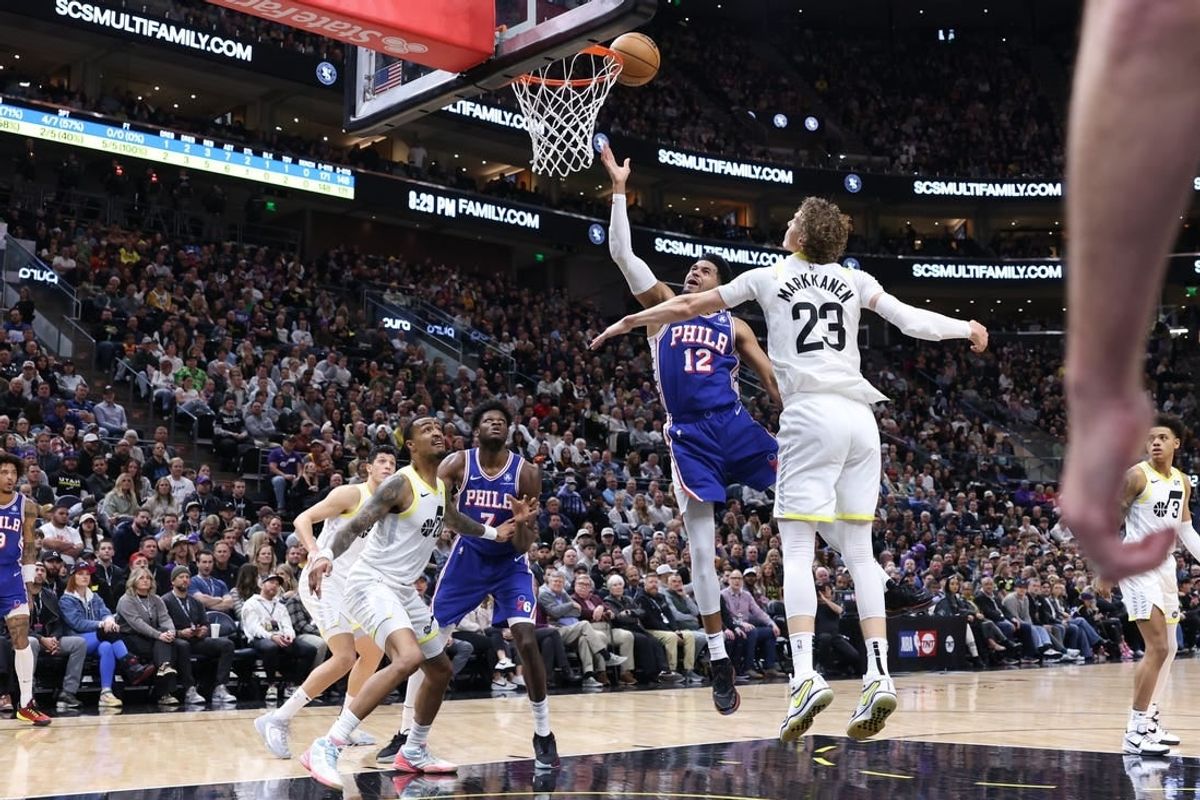 Feb 1, 2024; Salt Lake City, Utah, USA; Philadelphia 76ers forward Tobias Harris (12) lays the ball up against Utah Jazz forward Lauri Markkanen (23) during the first quarter at Delta Center.
