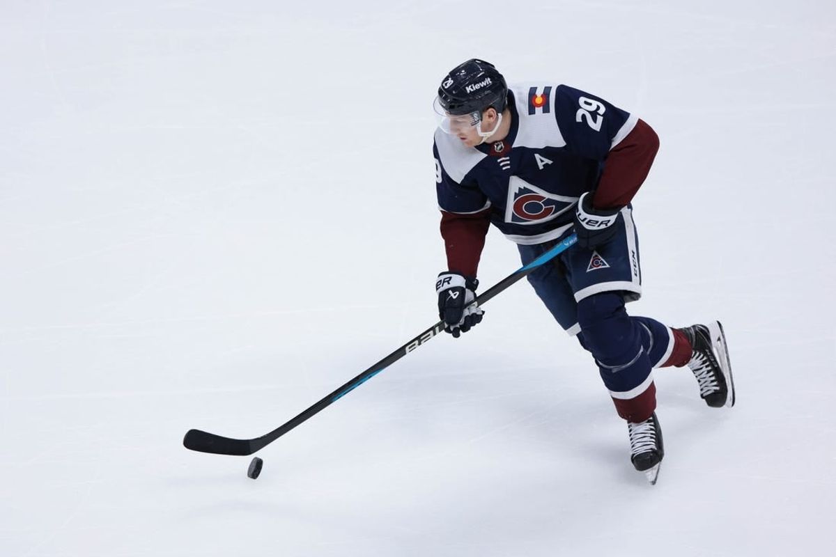 Mar 30, 2024; Denver, Colorado, USA; Colorado Avalanche center Nathan MacKinnon (29) skates with the puck during the third period against the Nashville Predators at Ball Arena.