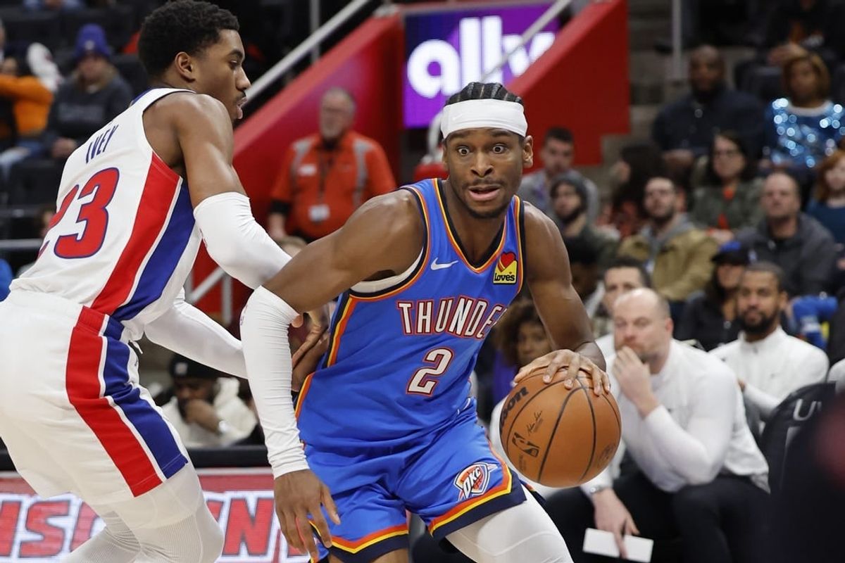 Jan 28, 2024; Detroit, Michigan, USA; Oklahoma City Thunder guard Shai Gilgeous-Alexander (2) dribbles defended by Detroit Pistons guard Jaden Ivey (23) in the first half at Little Caesars Arena.