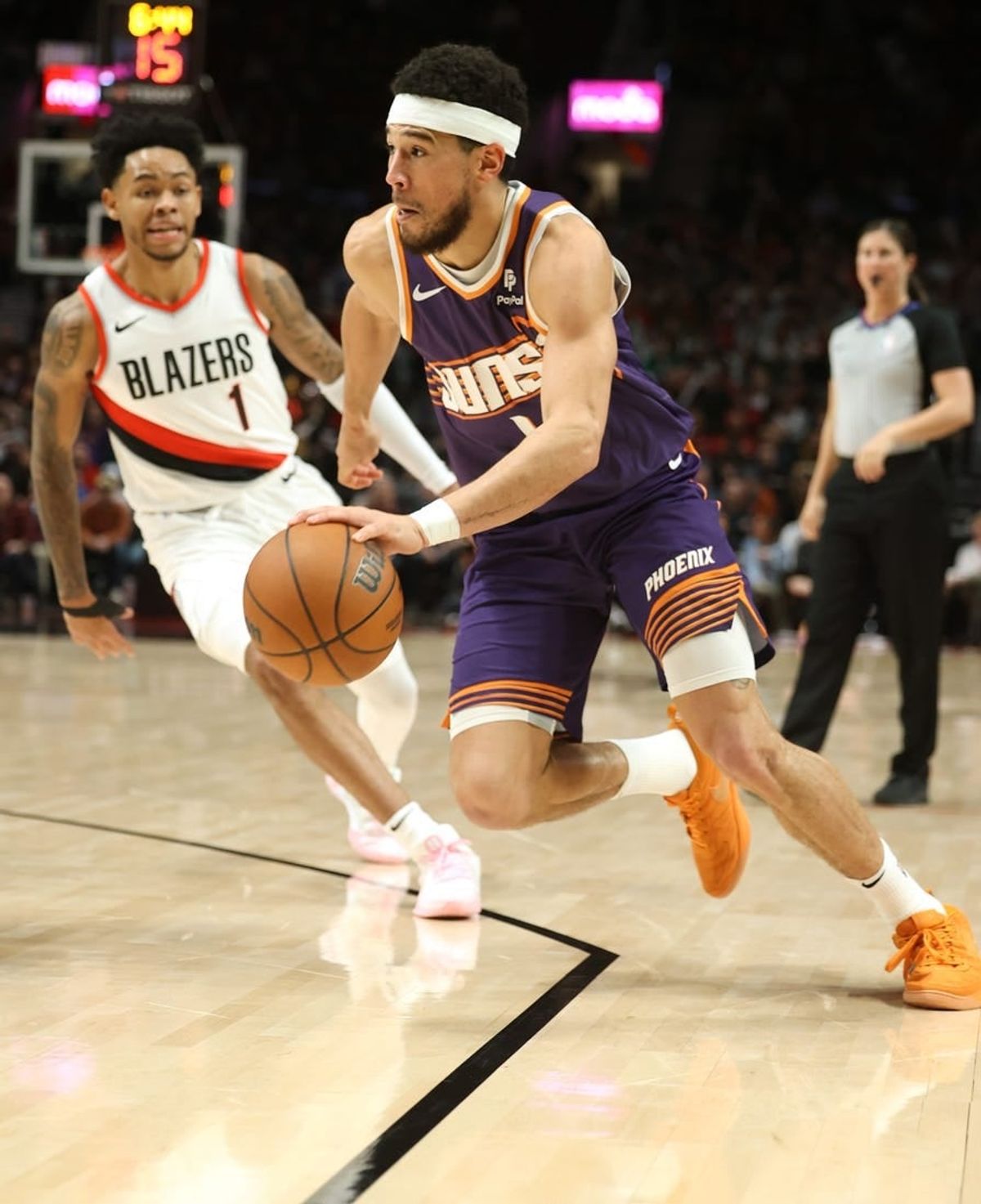 Dec 19, 2023; Portland, Oregon, USA; Phoenix Suns guard Devin Booker (1) drives the ball past Portland Trail Blazers guard Anfernee Simons (1) in the third quarter at Moda Center.