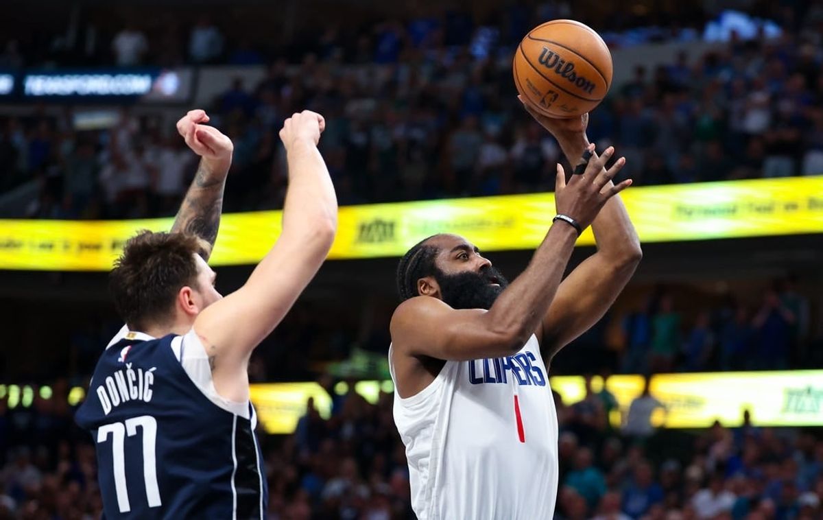 Apr 28, 2024; Dallas, Texas, USA;  LA Clippers guard James Harden (1) shoots past Dallas Mavericks guard Luka Doncic (77) during the second half during game four of the first round for the 2024 NBA playoffs at American Airlines Center.