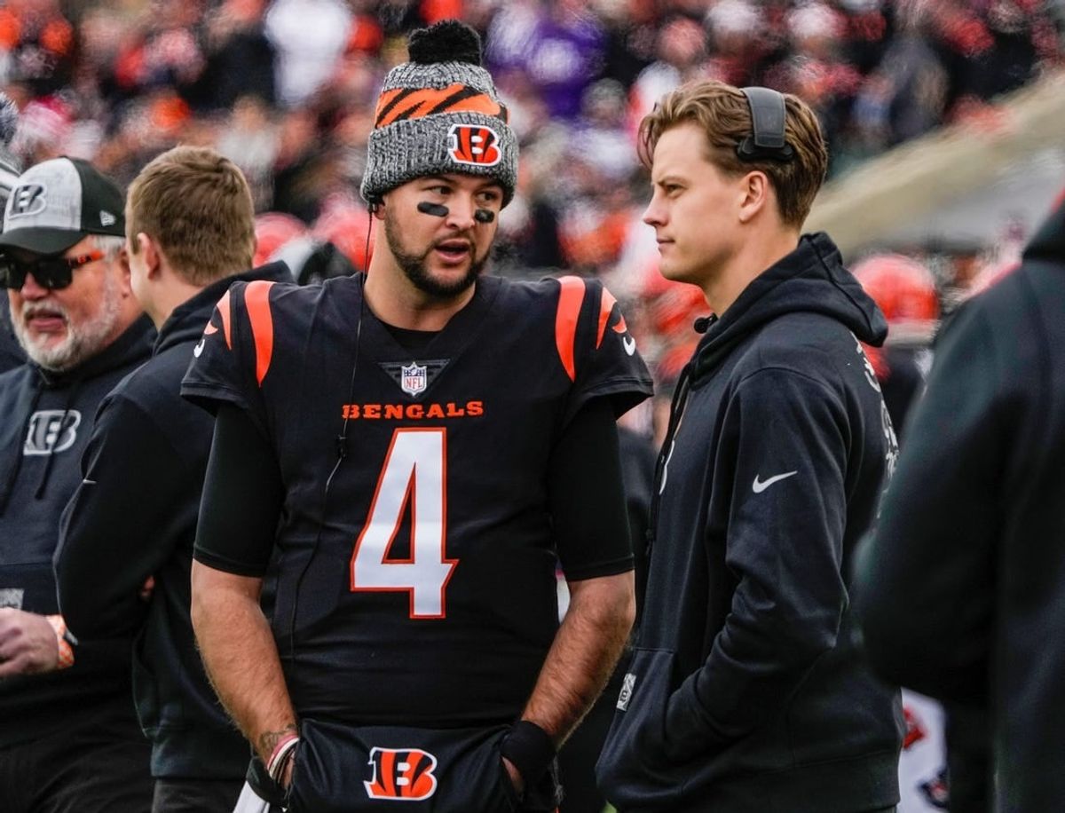 Cincinnati Bengals quarterbacks AJ McCarron (4) and Joe Burrow (9) talk as the Bengals take on Minnesota Vikings at Paycor Stadium Saturday, December 16, 2023.