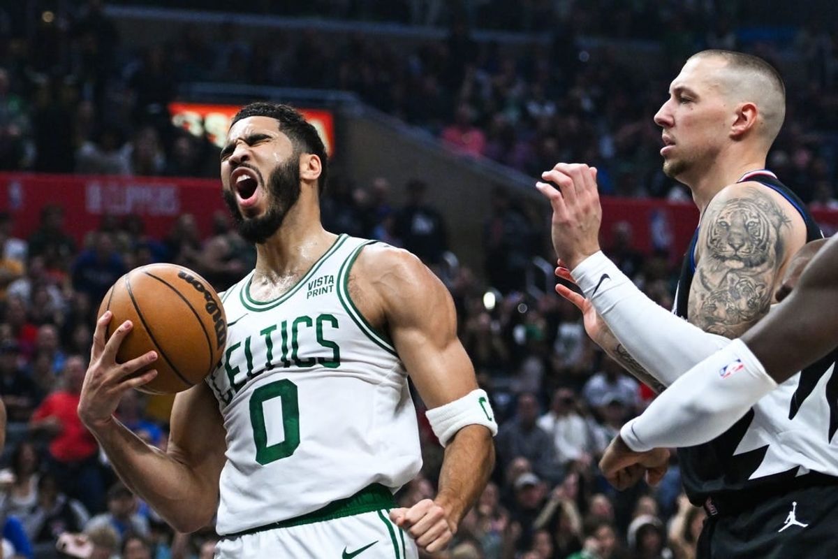 Dec 23, 2023; Los Angeles, California, USA; Boston Celtics forward Jayson Tatum (0) celebrates after scoring against Los Angeles Clippers center Daniel Theis (10) during the first quarter at Crypto.com Arena.