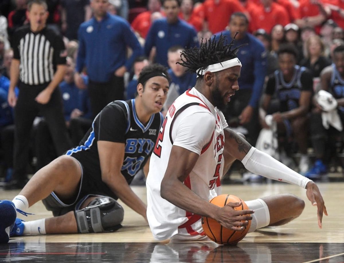 Texas Tech's forward Warren Washington (22) attempts to grab a loose ball against BYU in a Big 12 basketball game, Saturday, Jan. 20, 2024, at United Supermarkets Arena.