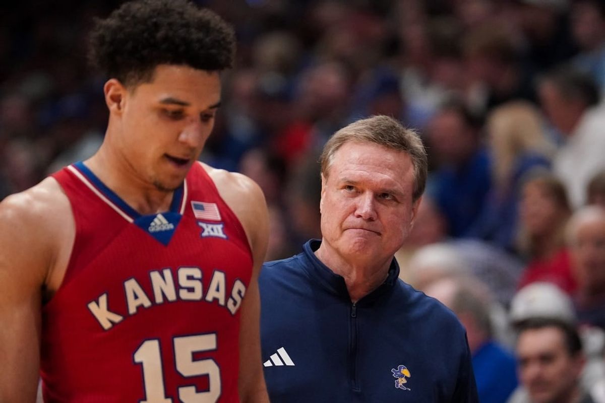 Mar 5, 2024; Lawrence, Kansas, USA; Kansas Jayhawks guard Kevin McCullar Jr. (15) talks with head coach Bill Self against the Kansas State Wildcats during the second half at Allen Fieldhouse.