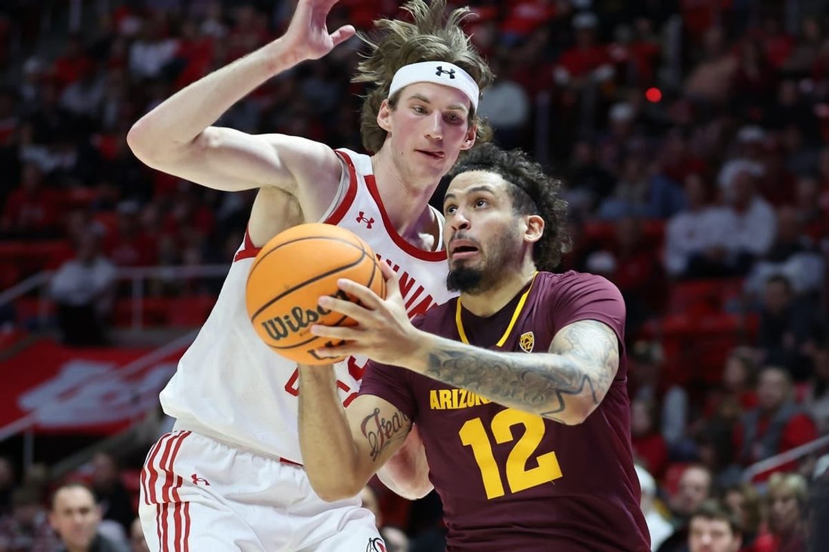 Feb 10, 2024; Salt Lake City, Utah, USA; Arizona State Sun Devils guard Jose Perez (12) goes to the basket against Utah Utes center Branden Carlson (35) during the first half at Jon M. Huntsman Center.