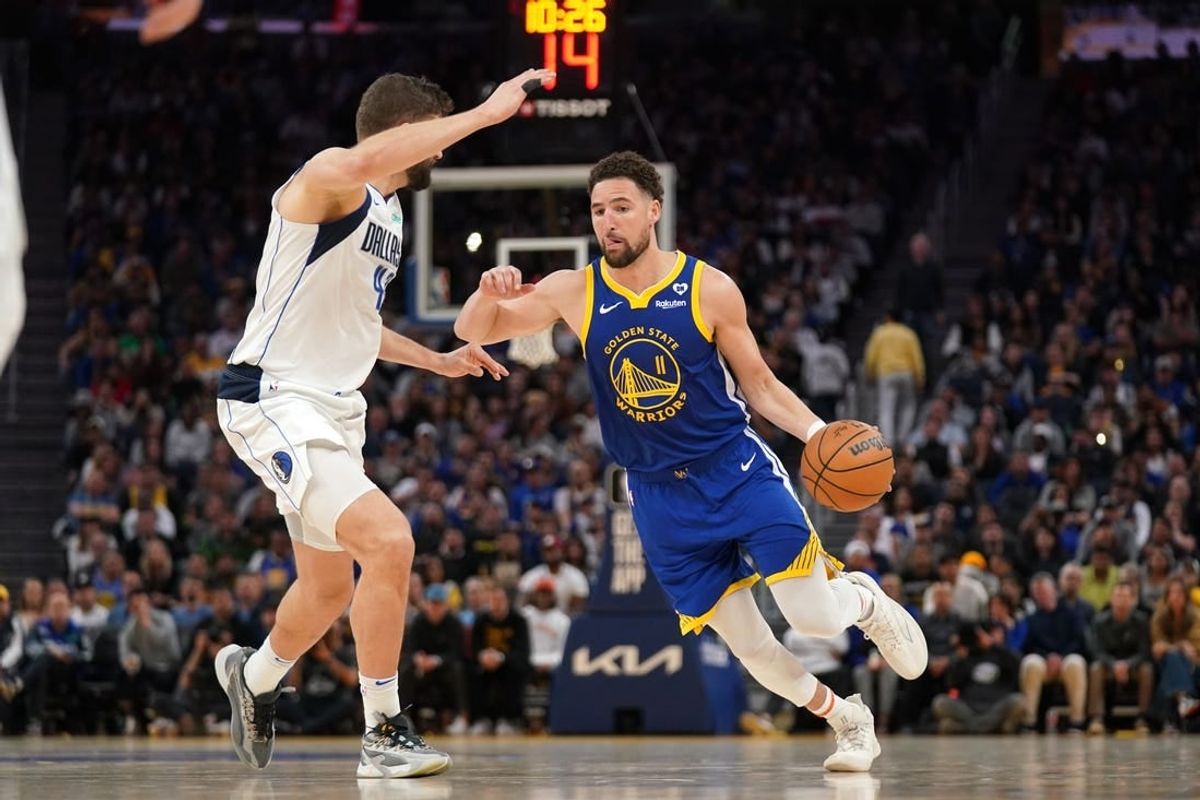 Apr 2, 2024; San Francisco, California, USA; Golden State Warriors guard Klay Thompson (11) dribbles the ball next to Dallas Mavericks forward Maxi Kleber (42) in the fourth quarter at the Chase Center.