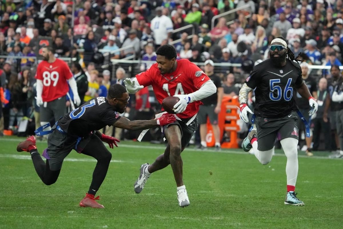 Feb 5, 2023; Paradise, Nevada, USA; AFC receiver Stefon Diggs of the Buffalo Bills (14) carries the ball against NFC strong safety Budda Baker of the Arizona Cardinals (3) and linebacker Demario Davis of the New Orleans Saints (56) during the Pro Bowl Games at Allegiant Stadium.