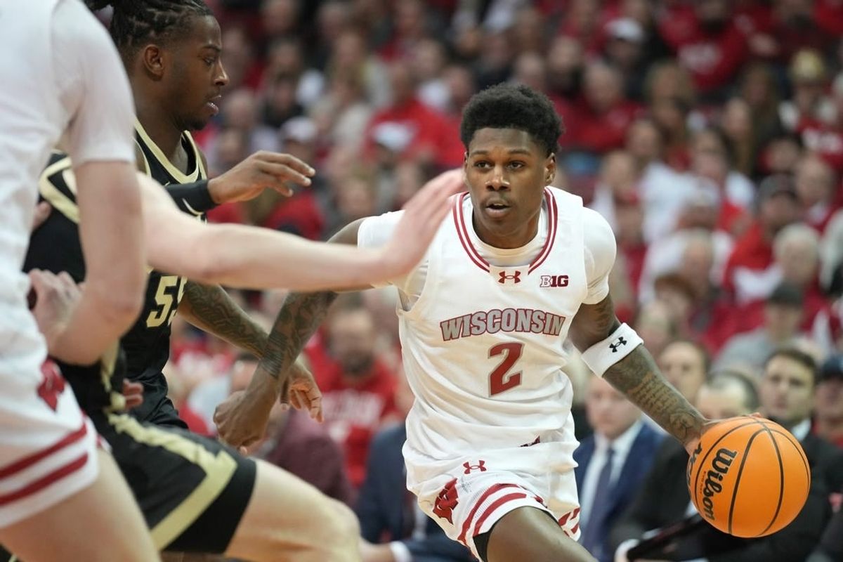 Feb 4, 2024; Madison, Wisconsin, USA; Wisconsin Badgers guard AJ Storr (2) dribbles the ball against Purdue Boilermakers guard Lance Jones (55) during the second half at the Kohl Center.