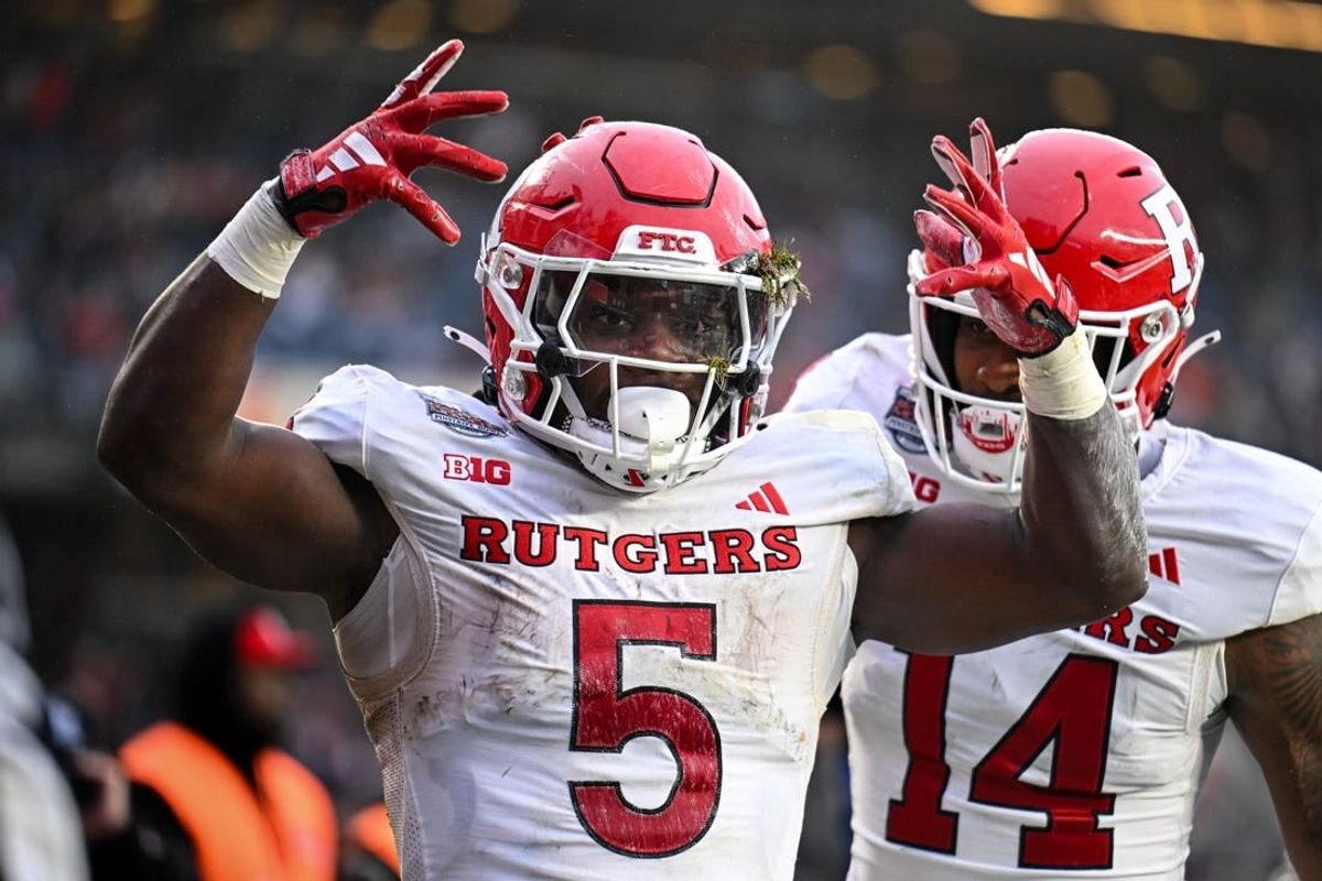 Dec 28, 2023; Bronx, NY, USA; Rutgers Scarlet Knights running back Kyle Monangai (5) celebrates his touchdown against Miami Hurricanes during the second quarter with Rutgers Scarlet Knights wide receiver Isaiah Washington (14) at Yankee Stadium.