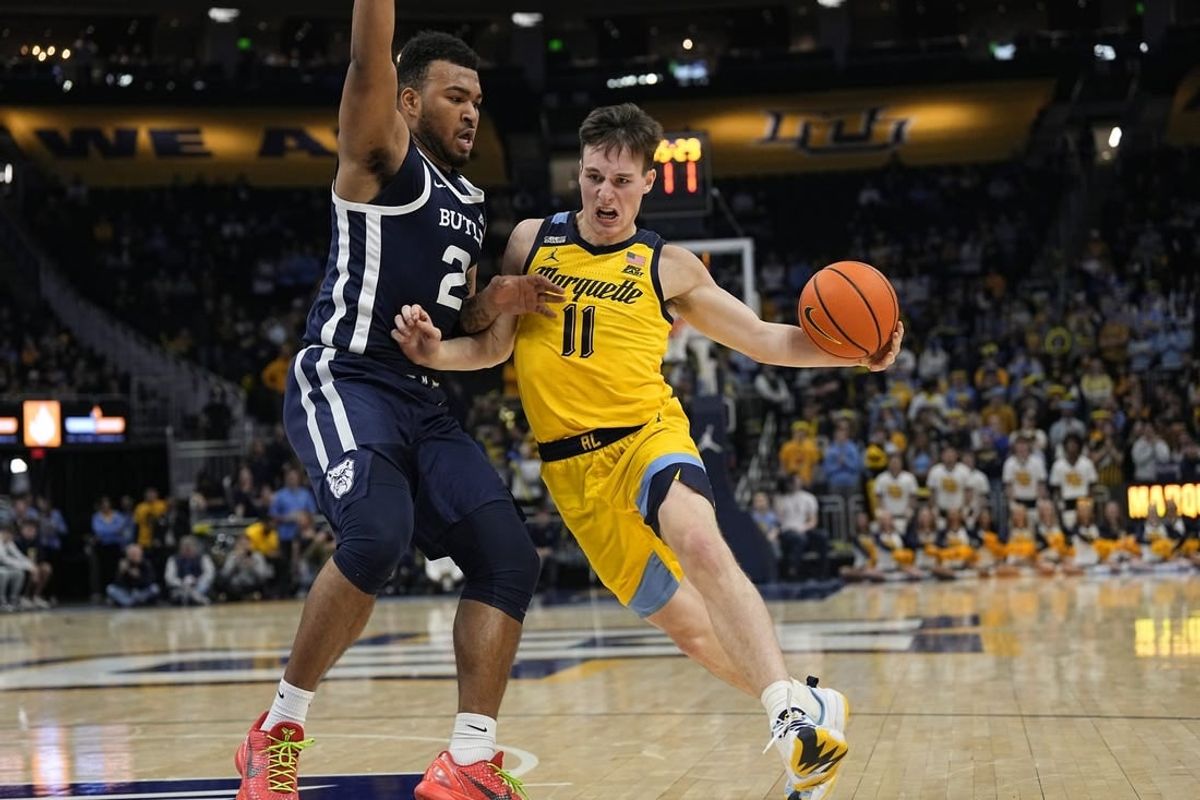 Jan 10, 2024; Milwaukee, Wisconsin, USA;  Marquette Golden Eagles guard Tyler Kolek (11) drives for the basket against Butler Bulldogs guard Pierre Brooks (21) during the second half at Fiserv Forum.
