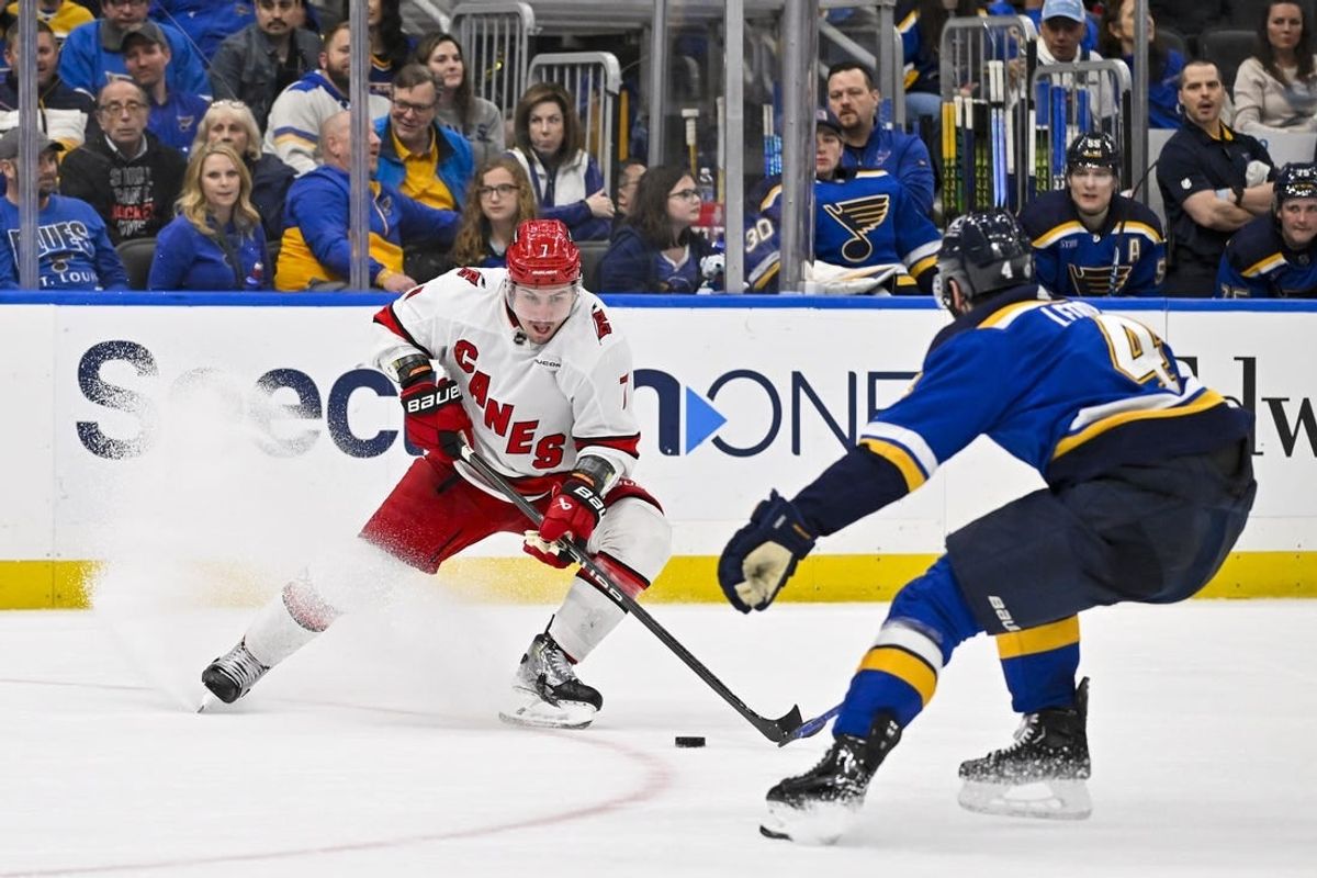 Apr 12, 2024; St. Louis, Missouri, USA;  Carolina Hurricanes defenseman Dmitry Orlov (7) controls the puck against the St. Louis Blues during the third period at Enterprise Center.