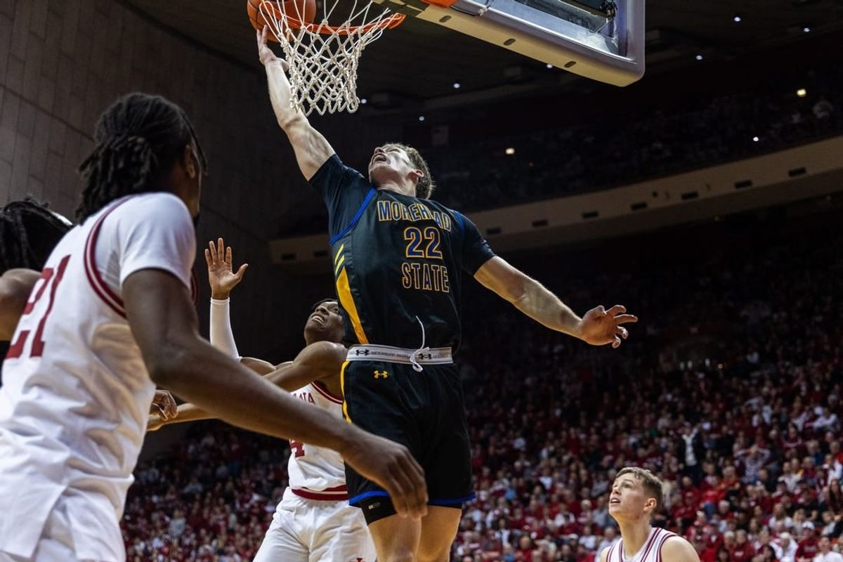 Dec 19, 2023; Bloomington, Indiana, USA; Morehead State Eagles guard Riley Minix (22) shoots the ball while Indiana Hoosiers forward Anthony Walker (4) defends in the second half at Simon Skjodt Assembly Hall.