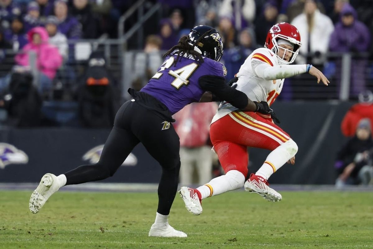 Jan 28, 2024; Baltimore, Maryland, USA; Kansas City Chiefs quarterback Patrick Mahomes (15) is knocked down after passing the ball by Baltimore Ravens linebacker Jadeveon Clowney (24) in the AFC Championship football game at M&T Bank Stadium.