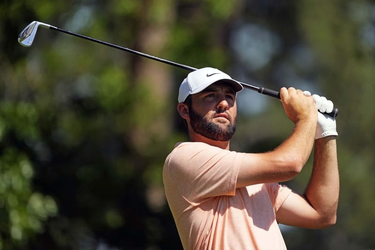 Apr 14, 2024; Augusta, Georgia, USA; Scottie Scheffler plays his shot from the fourth tee during the final round of the Masters Tournament.