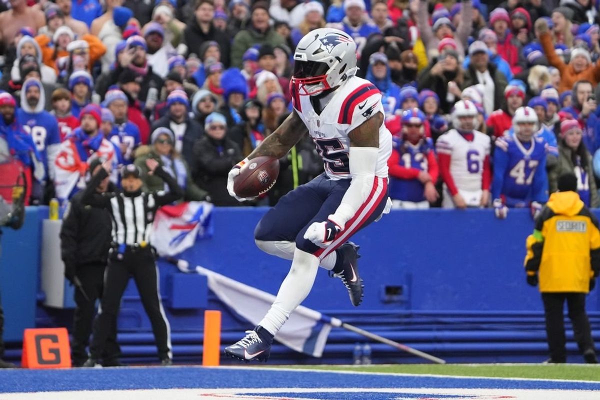 Dec 31, 2023; Orchard Park, New York, USA; New England Patriots running back Ezekiel Elliott (15) reacts to scoring a touchdown against the Buffalo Bills during the second half at Highmark Stadium.