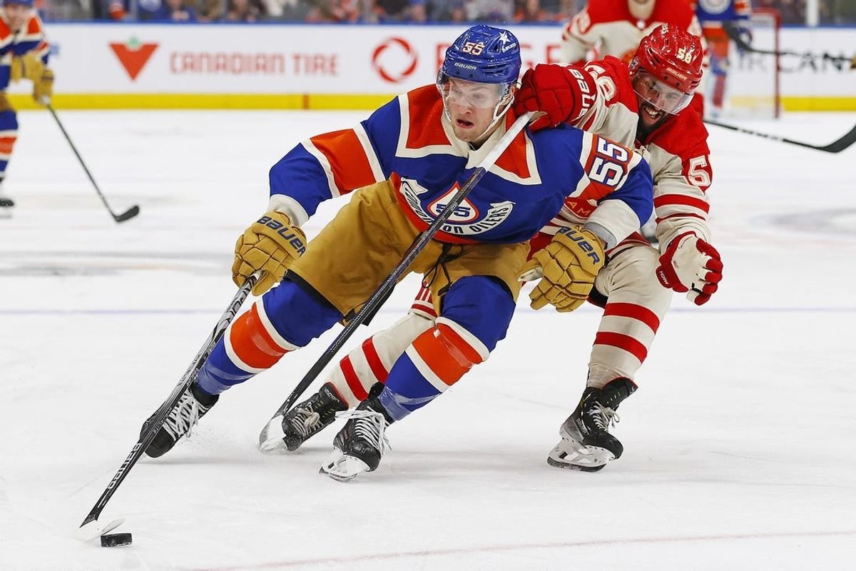 Feb 24, 2024; Edmonton, Alberta, CAN; Edmonton Oilers. forward Dylan Holloway (55) carries the puck around Calgary Flames defensemen Oliver Kylington (58) during the third period at Rogers Place.