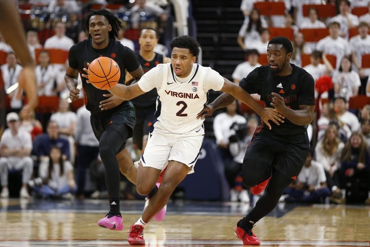 Feb 5, 2024; Charlottesville, Virginia, USA; Virginia Cavaliers guard Reece Beekman (2) dribbles the ball away from Miami (Fl) Hurricanes guard Bensley Joseph (4) during the second half at John Paul Jones Arena.