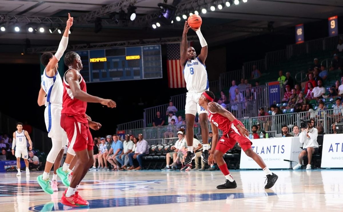 Nov 23, 2023; Paradise Island, BAHAMAS; Memphis Tigers forward David Jones (8) scores over Arkansas Razorbacks forward Chandler Lawson (8) right before halftime at Imperial Arena.
