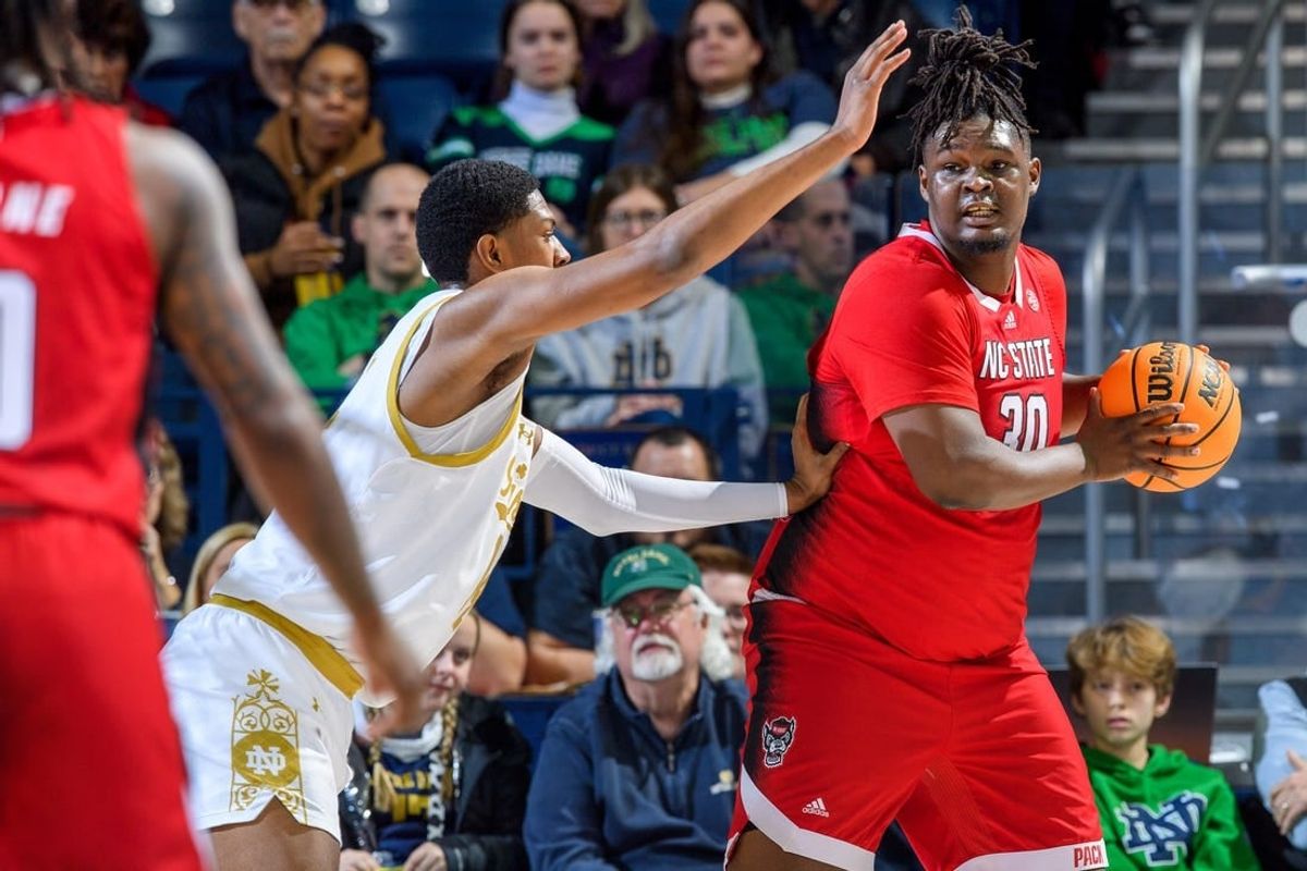 Jan 3, 2024; South Bend, Indiana, USA; North Carolina State Wolfpack forward DJ Burns, Jr. (30) looks to pass as Notre Dame Fighting Irish forward Kebba Njie (14) defends in the first half at the Purcell Pavilion.
