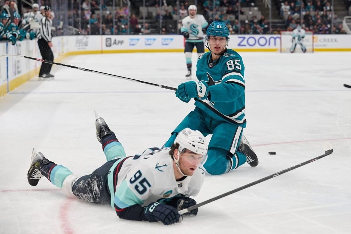 Jan 30, 2024; San Jose, California, USA; San Jose Sharks defenseman Shakir Mukhamadullin (85) and Seattle Kraken left wing Andre Burakovsky (95) after a penalty is called against Mukhamadullin during the first period at SAP Center at San Jose.