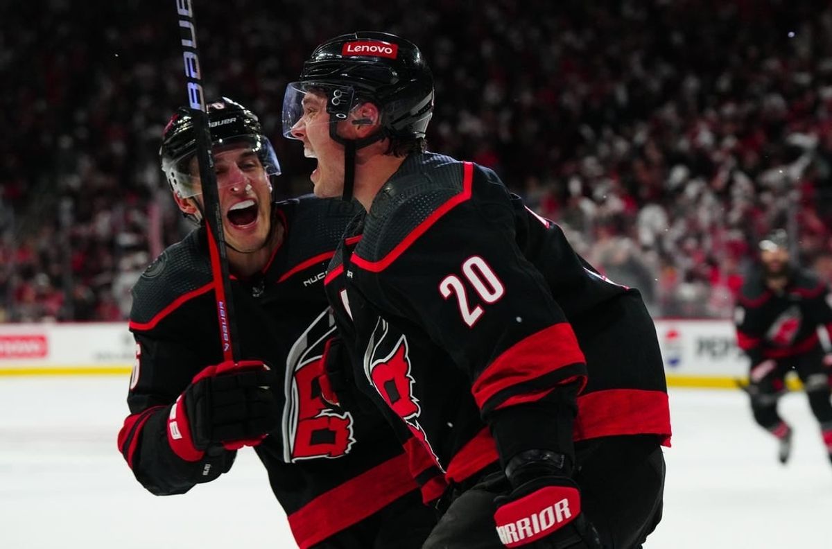 Apr 22, 2024; Raleigh, North Carolina, USA; Carolina Hurricanes center Sebastian Aho (20) celebrates his goal with defenseman Brady Skjei (76) against the New York Islanders during the third period in game two of the first round of the 2024 Stanley Cup Playoffs at PNC Arena.