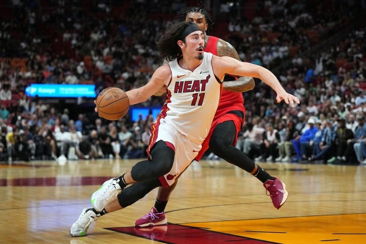 Apr 12, 2024; Miami, Florida, USA;  Miami Heat guard Jaime Jaquez Jr. (11) drives to the basket as Toronto Raptors center Malik Williams (35) defends during the first half at Kaseya Center.