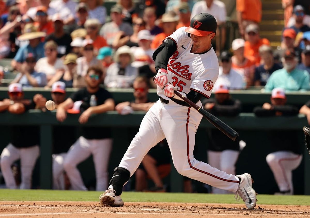 Mar 12, 2024; Sarasota, Florida, USA; Baltimore Orioles catcher Adley Rutschman (35) hits a RBI single during the second inning against the Tampa Bay Rays at Ed Smith Stadium.